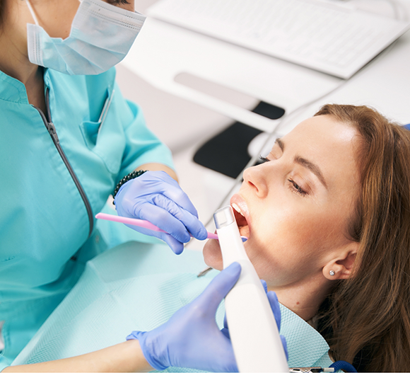 Dentist taking digital scans of a patient's teeth