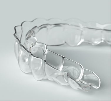 Clear aligner on a flat white surface