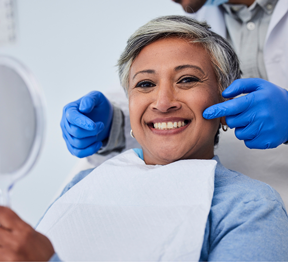 Dentist pointing to a patient's flawless smile