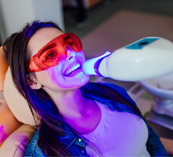 Dental patient getting her teeth whitened