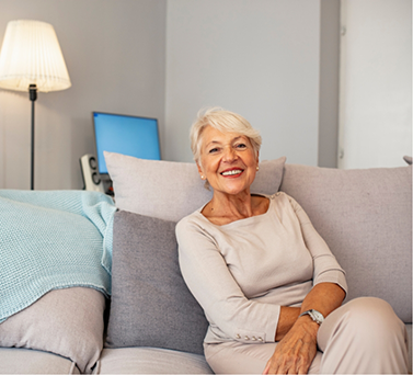 Senior woman smiling on her couch