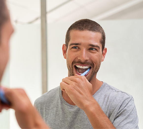 Young man brushing his teeth
