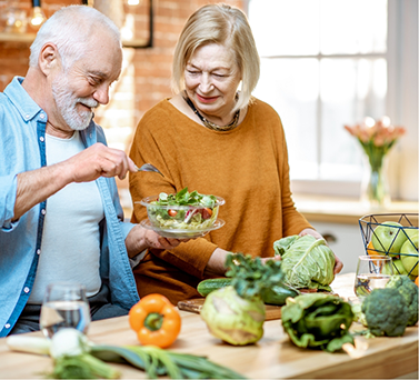 Senior couple making salad