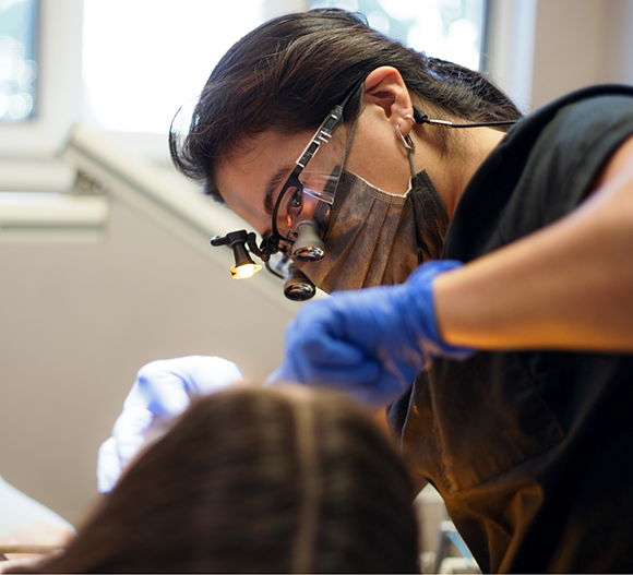 Dental professional examining a patient's teeth