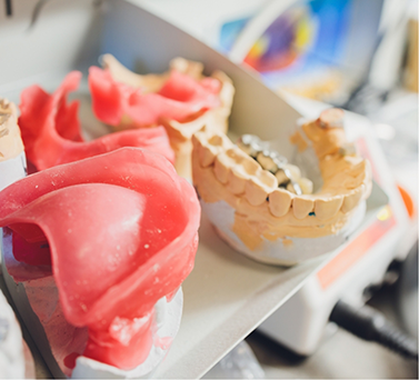 Several sets of dentures in a dental lab