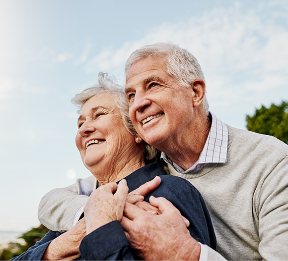 Senior couple hugging outdoors