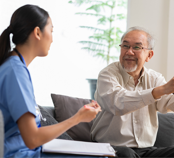 Senior man talking to a dental team member