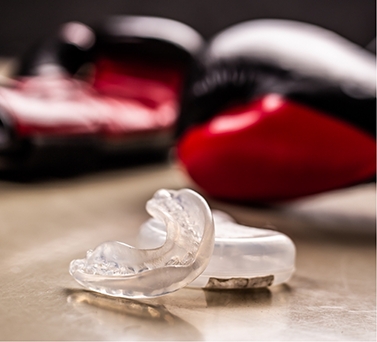 Mouthguard next to boxing gloves