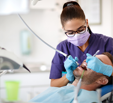 Dental hygienist cleaning a patient's teeth