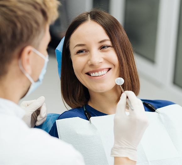 Woman smiling at her dentist during a checkup