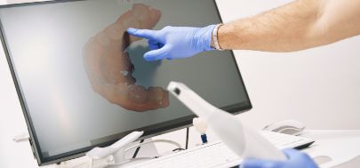 Dentist looking at digital impressions of a patient's teeth