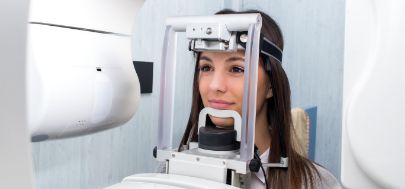 Dental patient getting a CT cone beam scan of her mouth and jaws