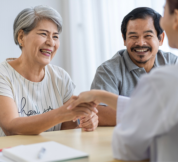 Woman shaking hands with her dentist