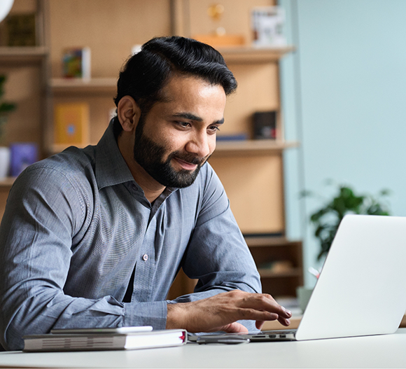 Man at a table using a laptop