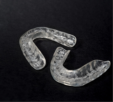 Two clear occlusal splint trays