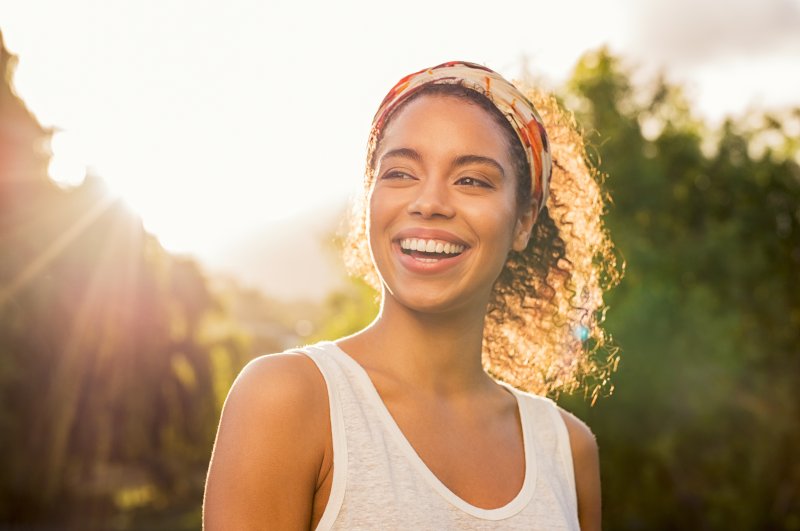 Woman smiling outside.