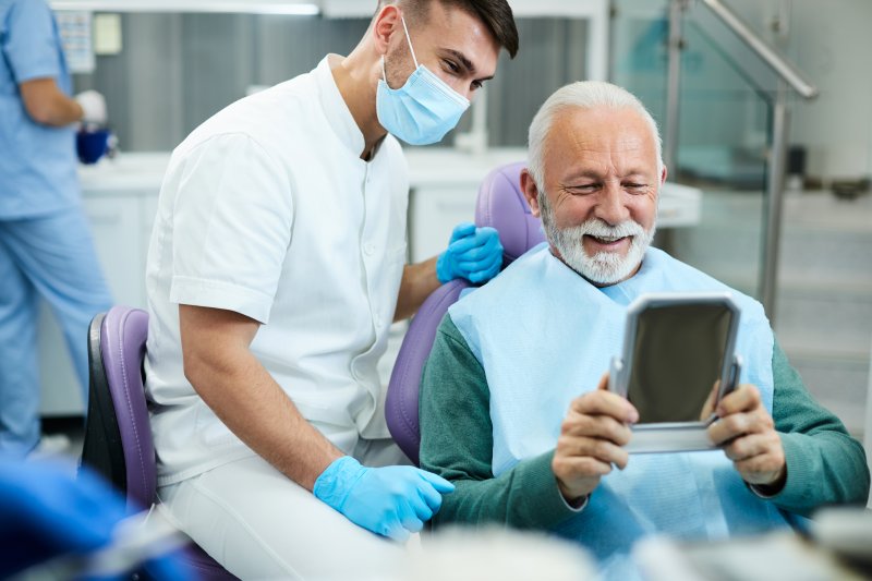 A patient looking in the mirror after a dental cleaning.