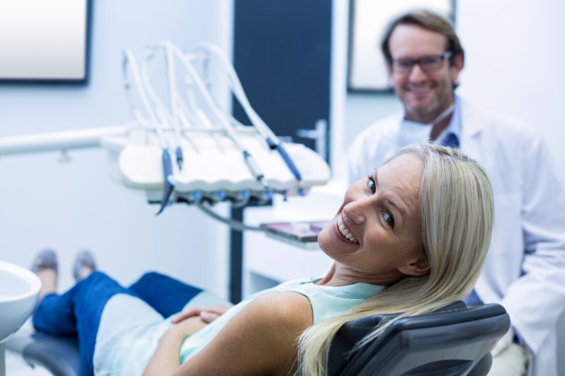 Person smiling after being treated by cosmetic dentist.