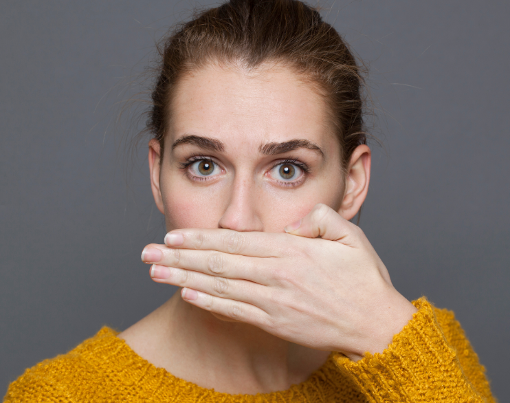 Woman covering mouth.